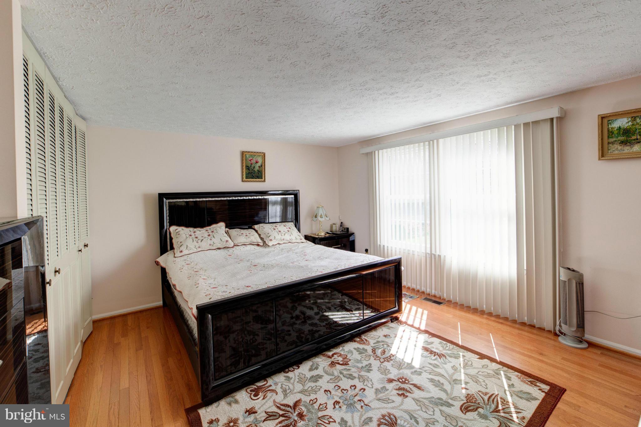 3116 Beethoven Way Silver Spring, MD 20904 - Photo 24 of 30 a bedroom with a bed and wooden floor