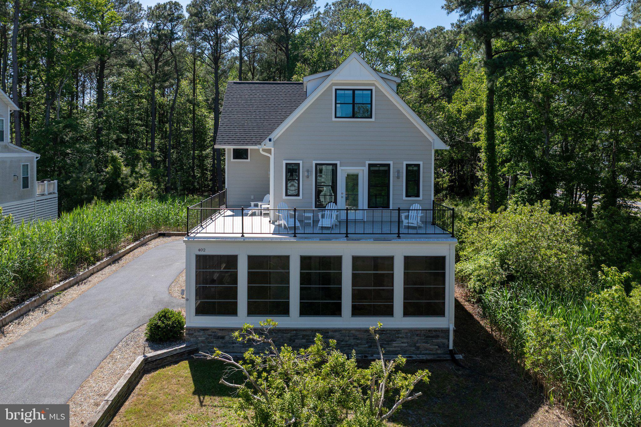 402 Salt Pond Road Bethany Beach, DE 19930 - Photo 2 of 55 Charming home nestled in lush greenery.