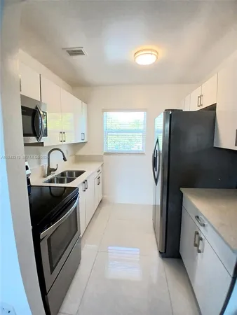 a kitchen with a refrigerator sink and stove