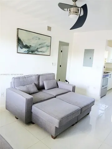 a bedroom with a bed couch and wall painting