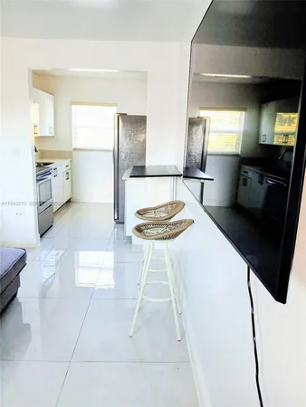 a kitchen with a sink cabinets and appliances