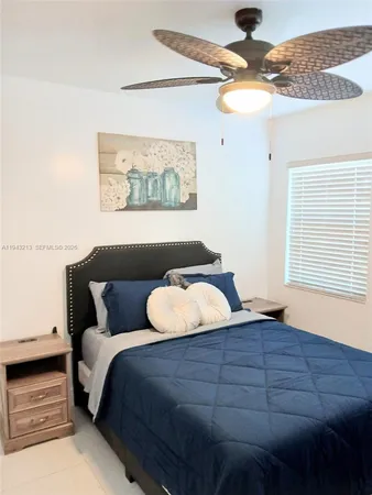 a bedroom with bed and window