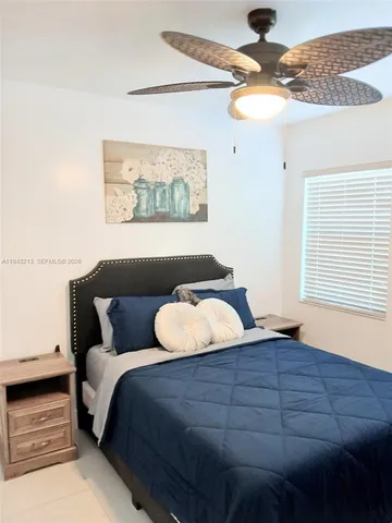 a bedroom with bed and window