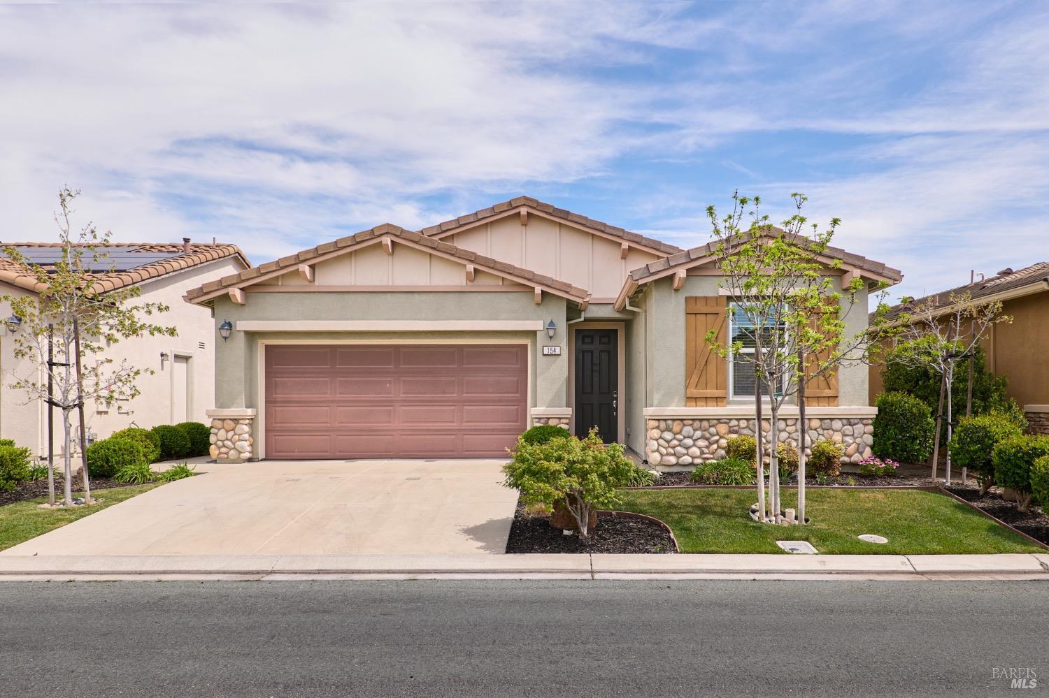 a front view of a house with garden