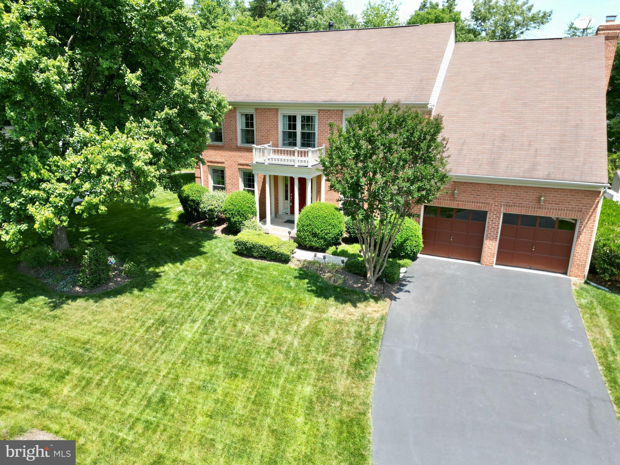 a aerial view of a house with yard and green space