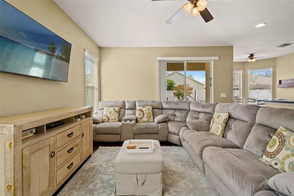 a kitchen with stainless steel appliances granite countertop a refrigerator a stove and a sink with wooden floor