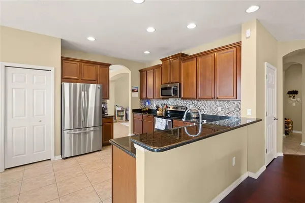 a spacious bedroom with a bed and a chandelier