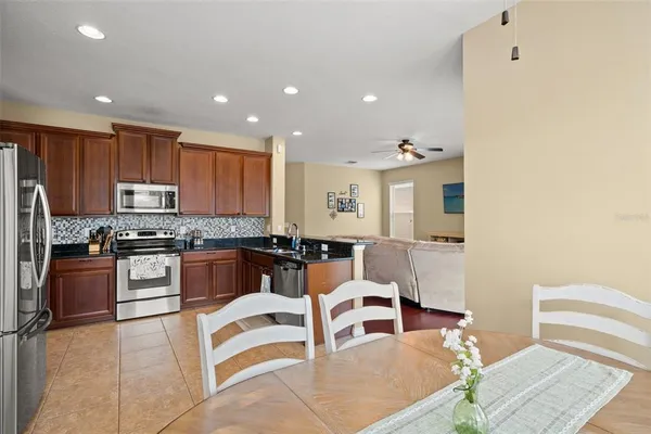 a spacious bedroom with a bed a couch and a chandelier
