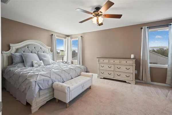 a view of a hallway with wooden floor and a bathroom