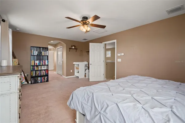 a bathroom with a large tub shower and sink