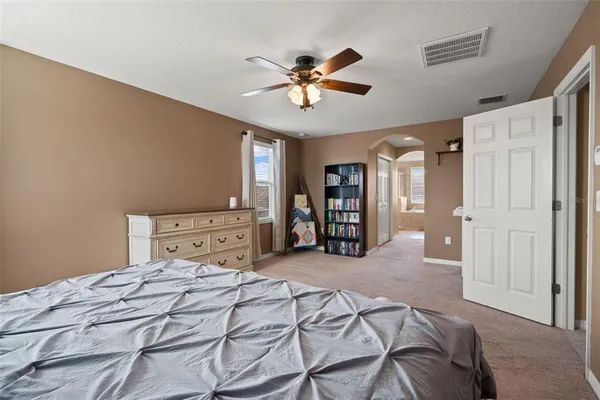 a bathroom with a tub a sink and a large mirror