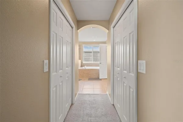 a bedroom with a bed a table and chair