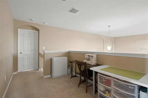 a view of swimming pool with outdoor seating and trees in the background