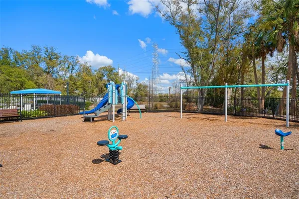 an aerial view of residential houses with outdoor space and parking