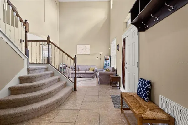 a living room with furniture chandelier and a window