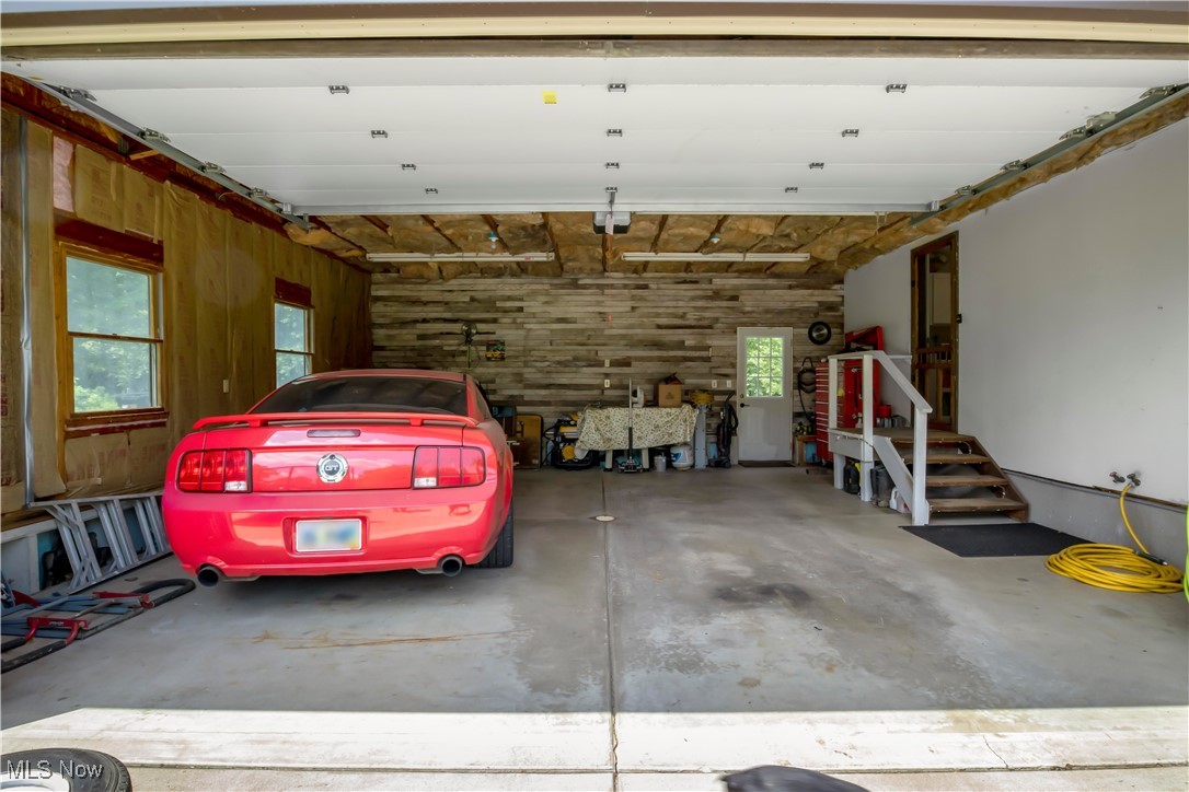 1264 Ellsworth Bailey Road Warren, OH 44481 - Photo 45 of 45 Garage featuring wood walls and a garage door opener