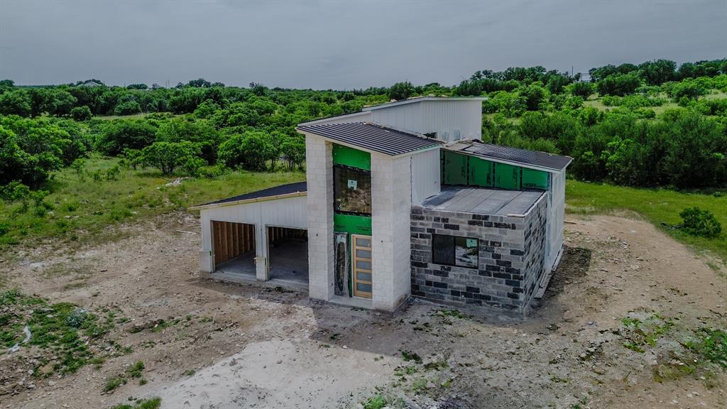 7108 Hells Gate Loop Strawn, TX 76475 - Photo 5 of 17 a view of a house with a yard and sitting area
