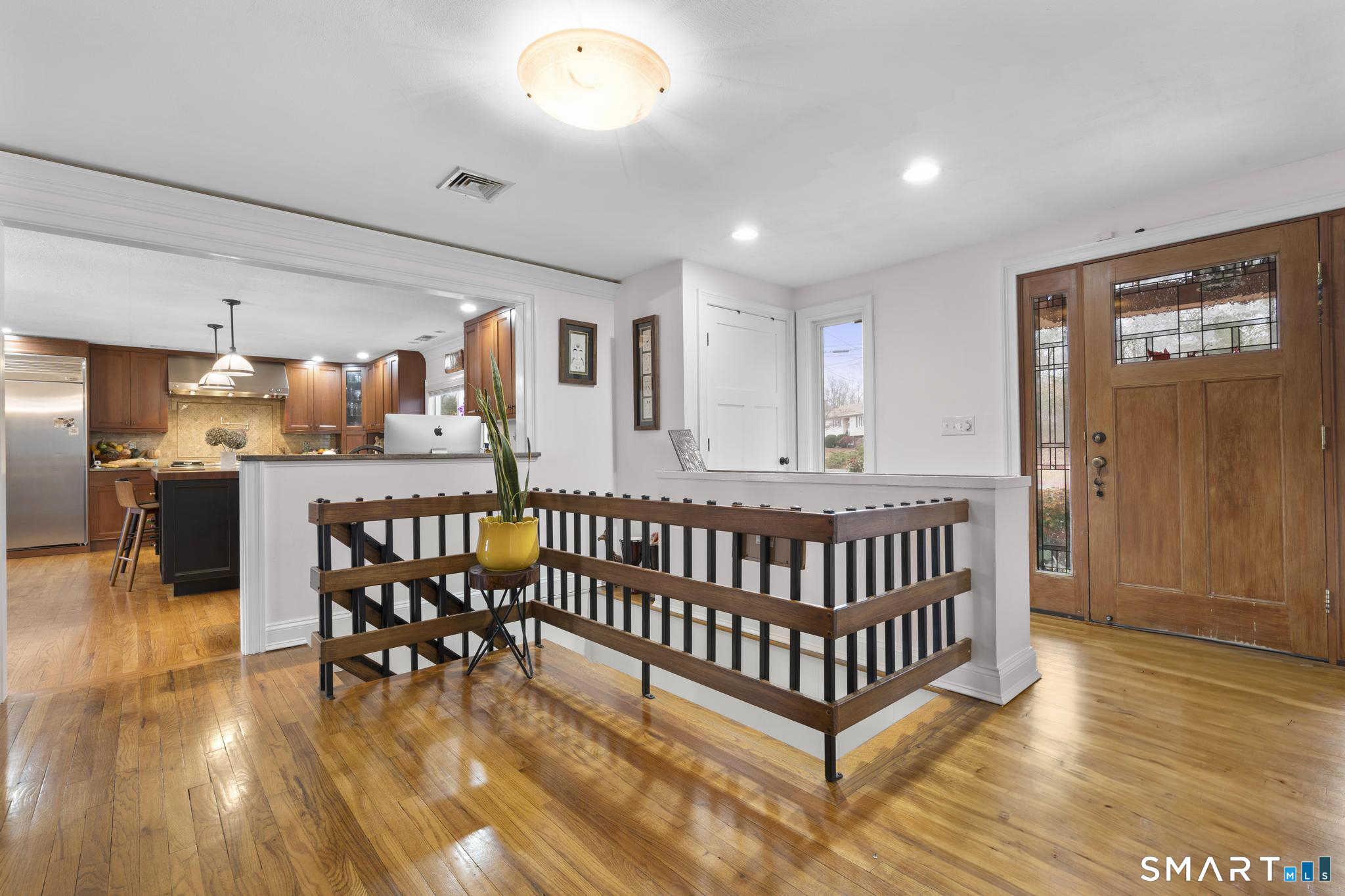 57 Gray Rock Road Trumbull, CT 06611 - Photo 22 of 40 a view of a hallway with dining room and wooden floor