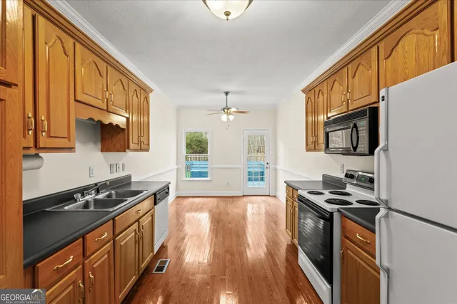 a kitchen with stainless steel appliances a stove sink and microwave