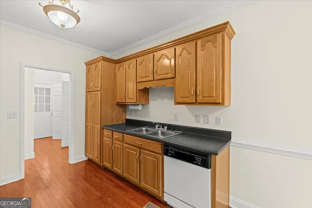 a kitchen with stainless steel appliances granite countertop a sink stove and cabinets