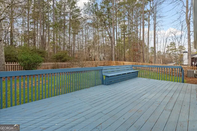 a view of a balcony with wooden floor and fence