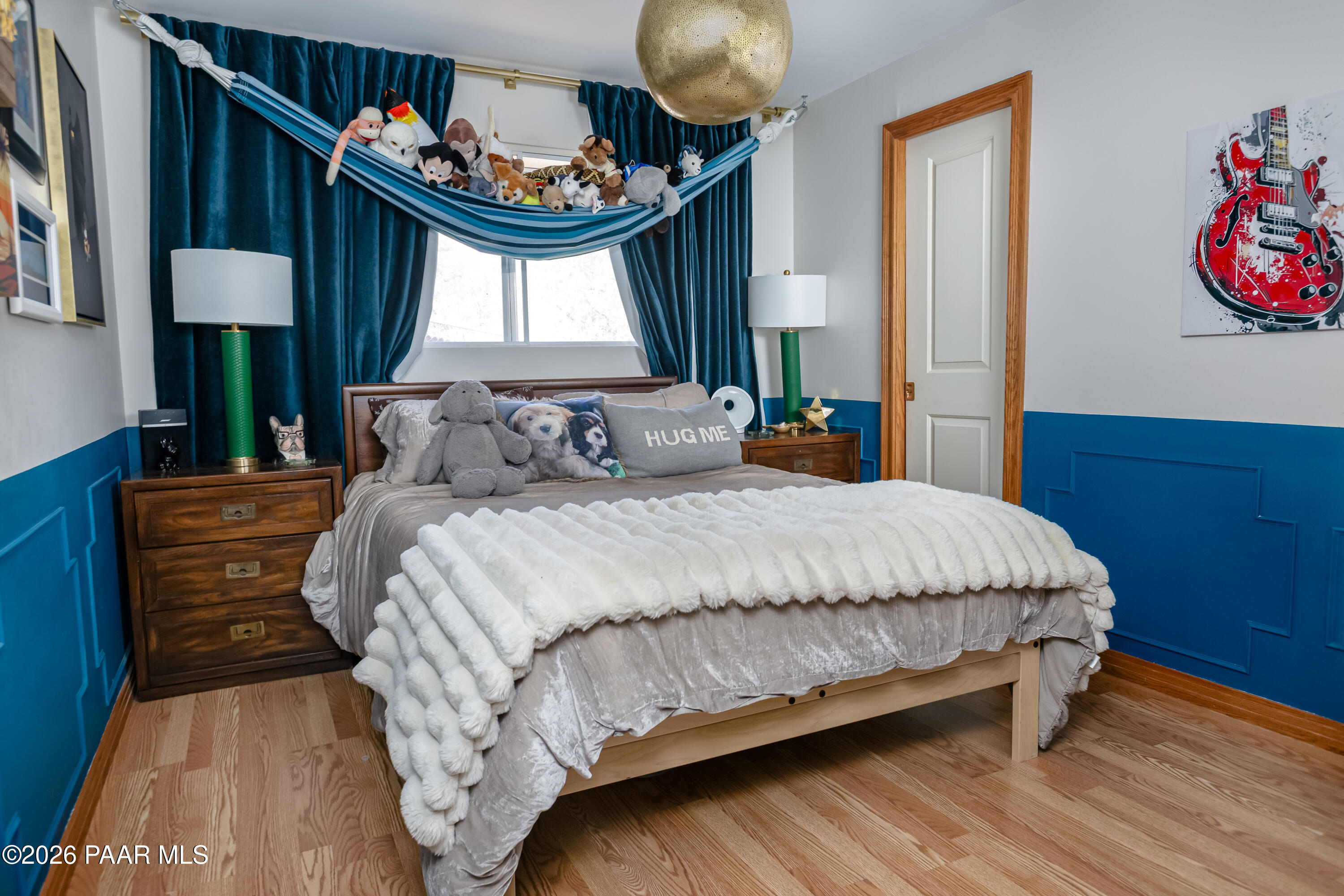 372 Verde Lane Prescott, AZ 86303 - Photo 13 of 23 a bedroom with a bed a dresser and painting on the wall