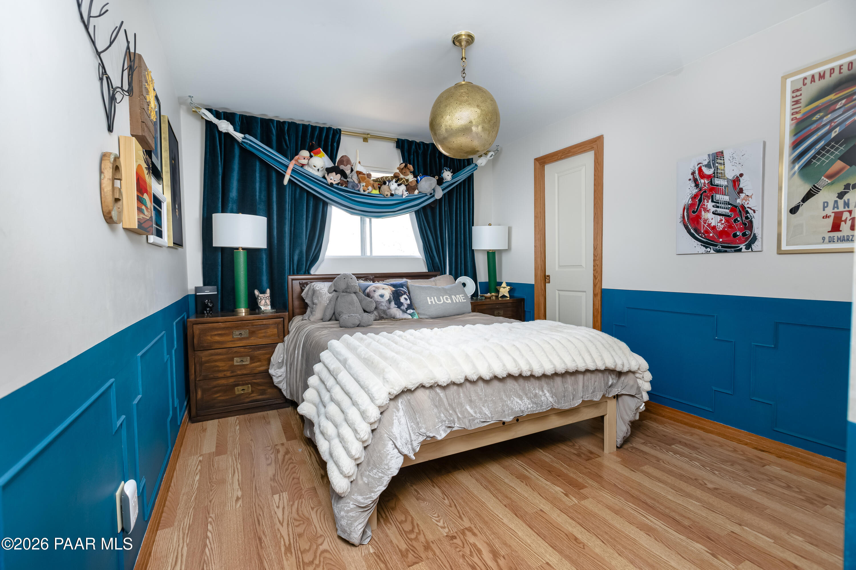 372 Verde Lane Prescott, AZ 86303 - Photo 14 of 23 a bedroom with a large bed and a chandelier