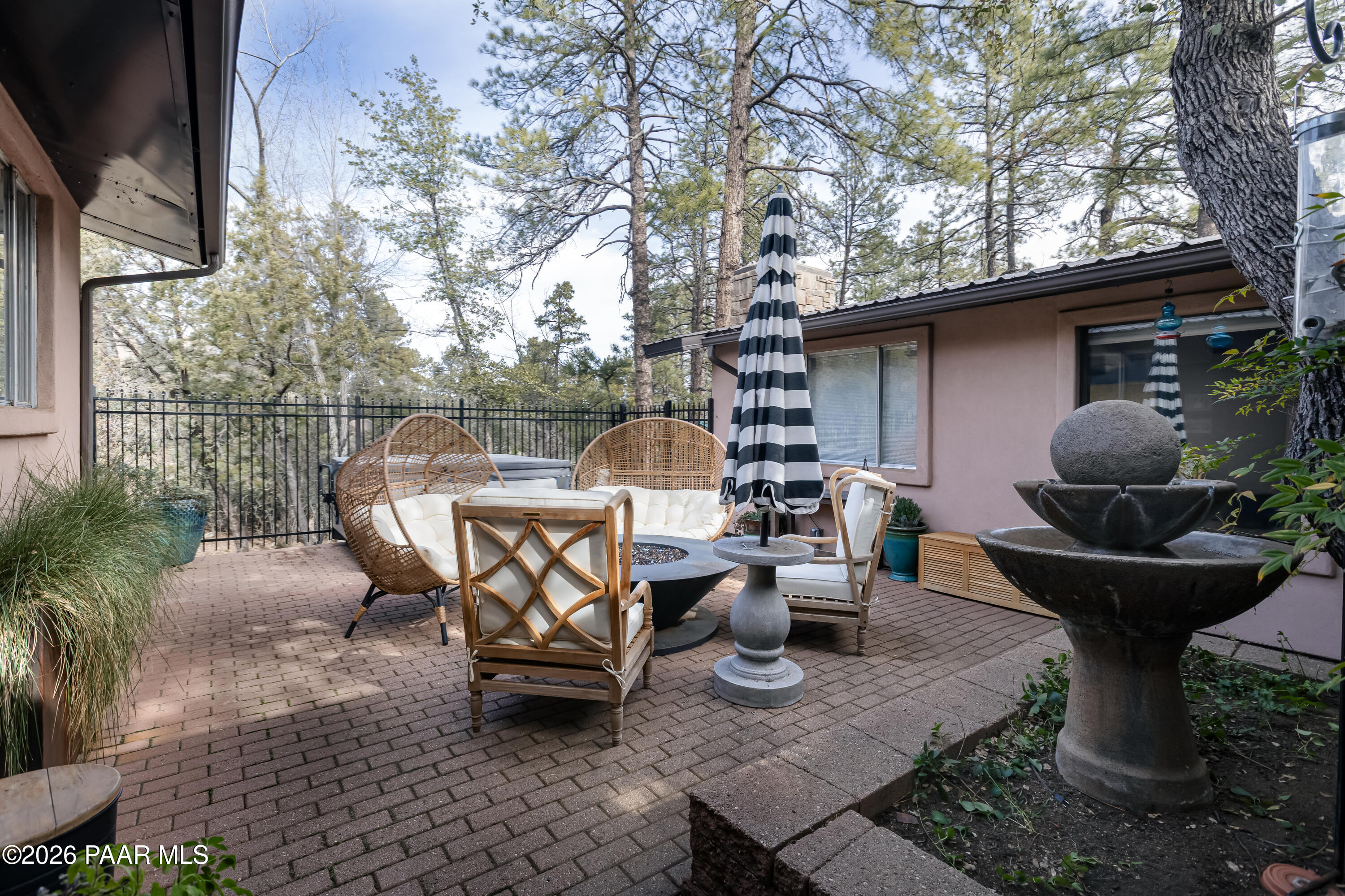 372 Verde Lane Prescott, AZ 86303 - Photo 21 of 23 a view of a patio with table and chairs potted plants and a large tree