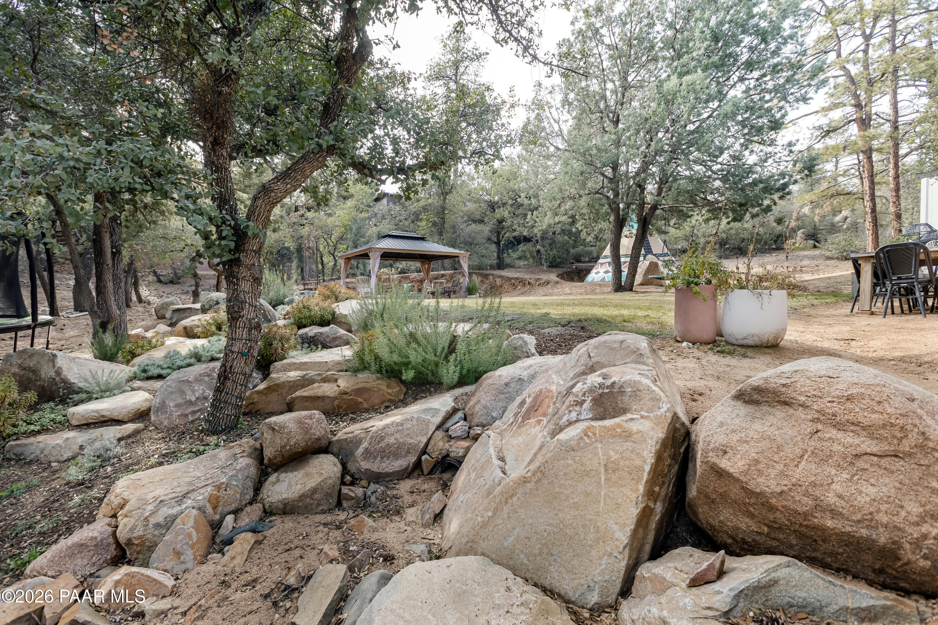 372 Verde Lane Prescott, AZ 86303 - Photo 22 of 23 a view of a backyard with couches and large trees