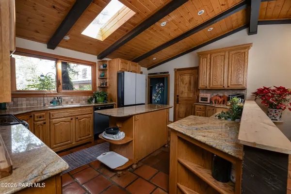 a kitchen with a table chairs stove and granite counter top