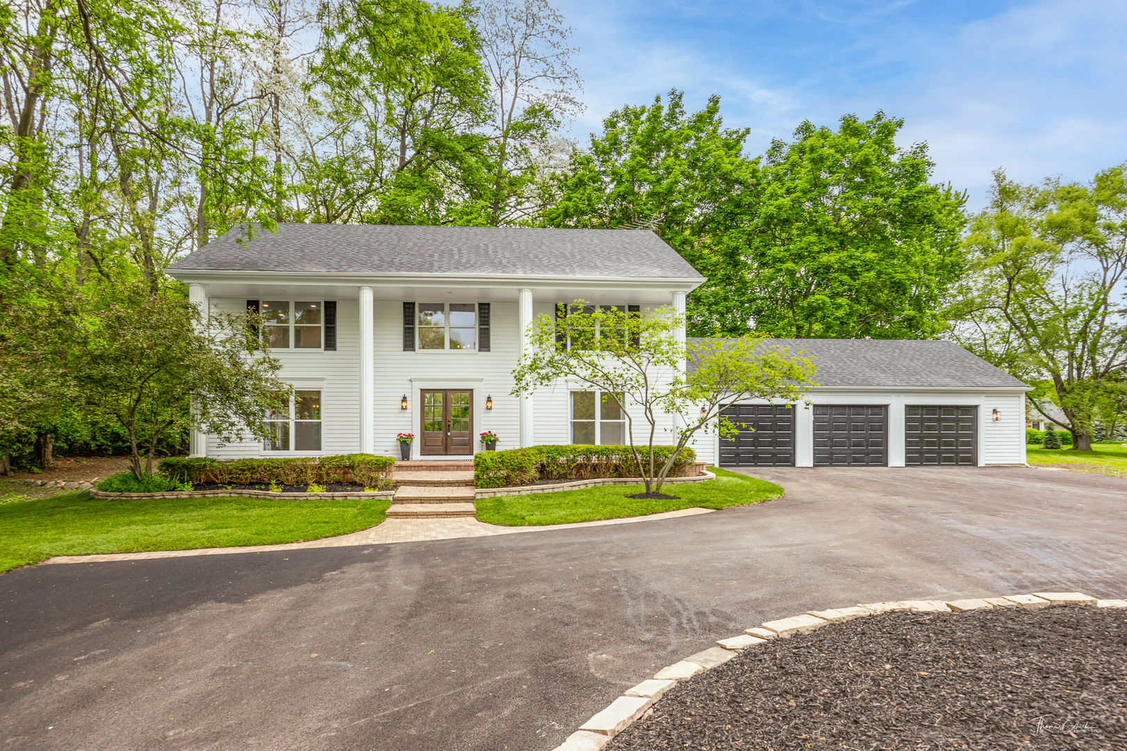 27036 West Miller Road Lake Barrington, IL 60010 - Photo 2 of 52 a front view of a house with garden and trees
