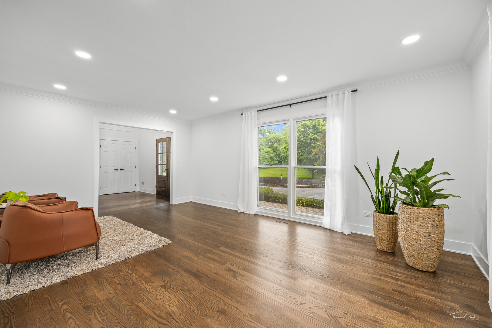 27036 West Miller Road Lake Barrington, IL 60010 - Photo 6 of 52 a hallway with a potted plant and wooden floor