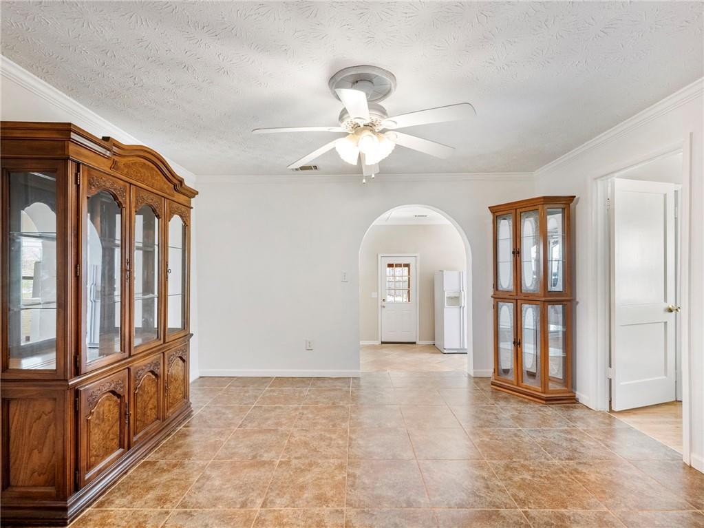 1686 Shoal Creek Road Monroe, GA 30656 - Photo 10 of 50 a view of an empty room with chandelier fan and wooden floor