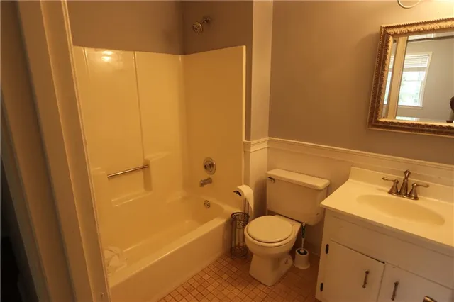 a bathroom with a toilet a sink and bathtub