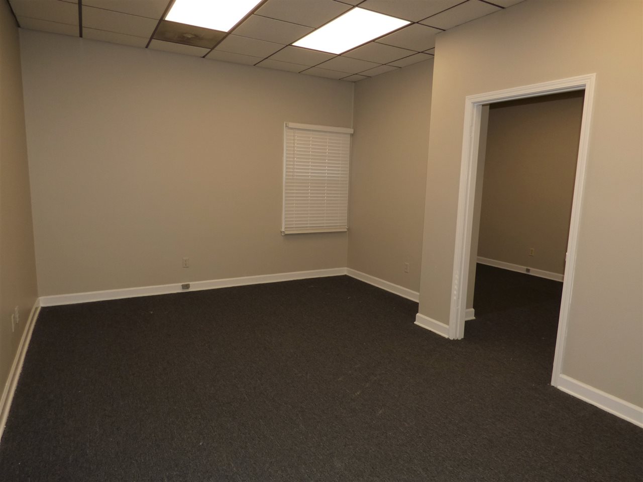 2959 Elmore Park Road, Unit 8 Bartlett, TN 38134 - Photo 4 of 4 an empty room with wooden floor and windows
