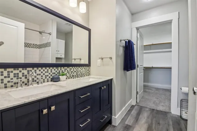 a bathroom with a double vanity sink and mirror