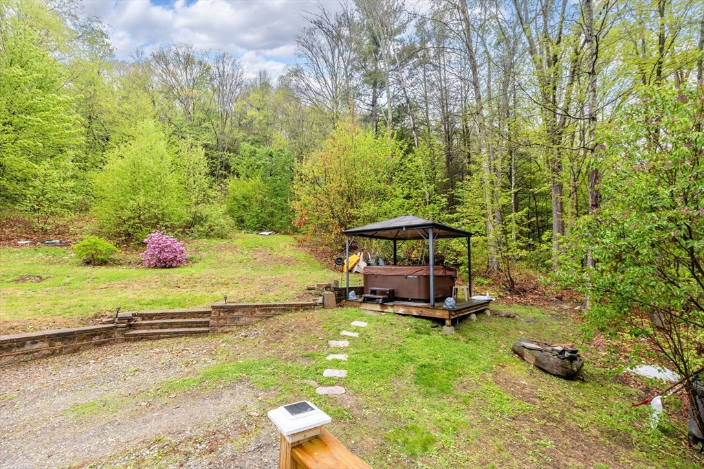 302 Middlefield Road Chester, MA 01011 - Photo 4 of 42 a view of a backyard with lawn chairs and iron fence