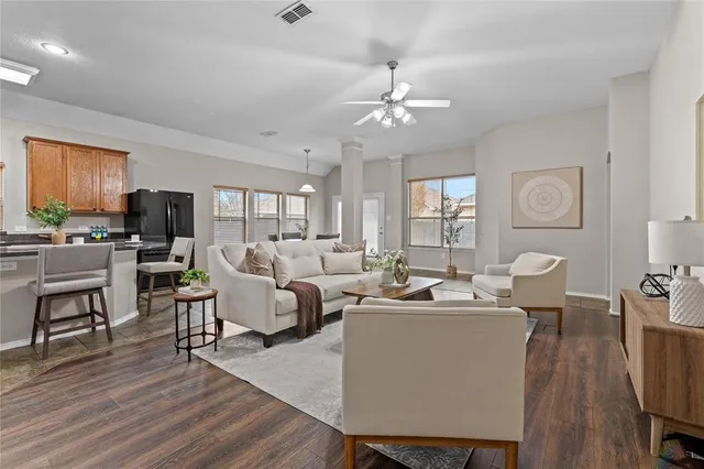 a living room with fireplace furniture and a wooden floor