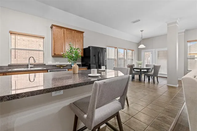 a kitchen with granite countertop lots of counter top space and dining table