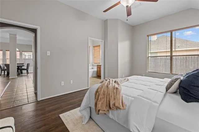 a bed sitting in a bedroom next to a window