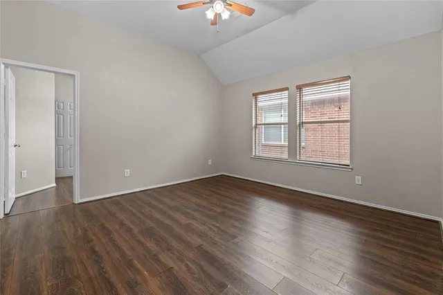 a view of a house with a yard and potted plants
