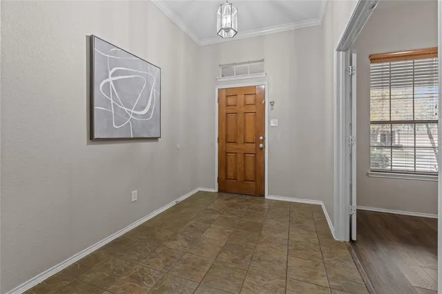a view of an empty room with closet and a window