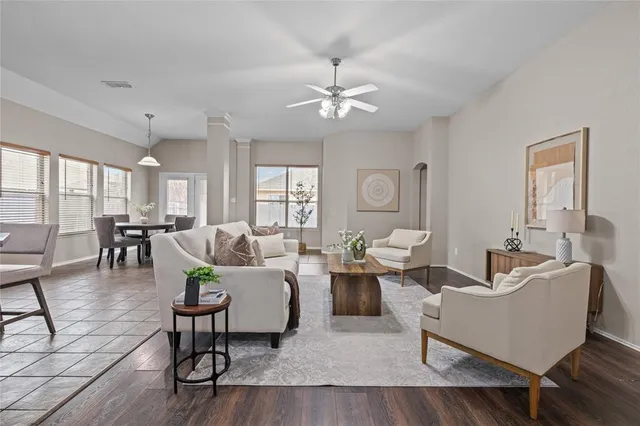a living room with furniture and wooden floor