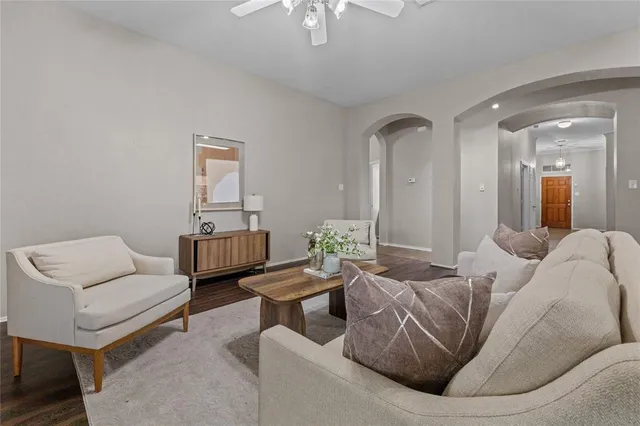 a living room with furniture and a potted plant
