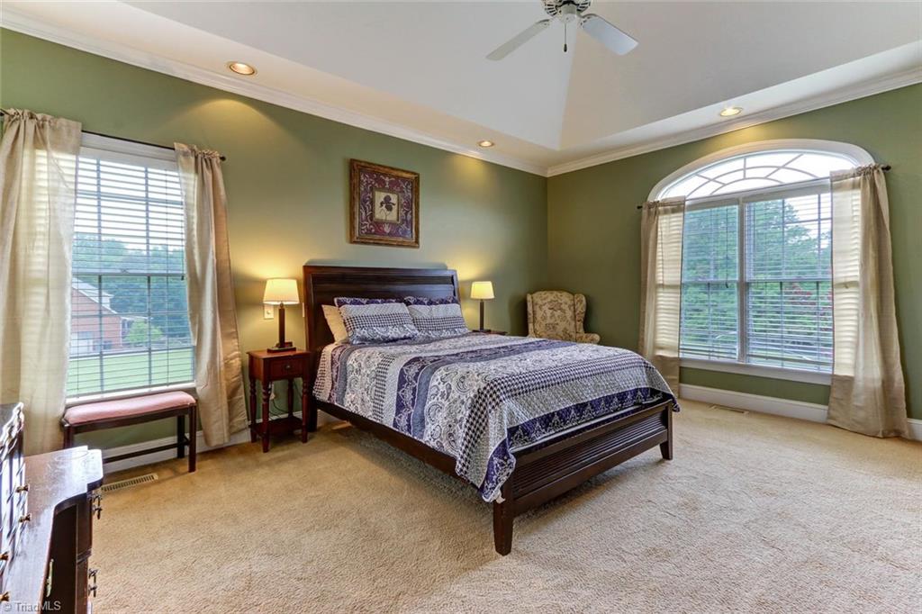5203 Red Fox Drive Oak Ridge, NC 27310 - Photo 14 of 30 After a long day, escape to your expansive and main level master suite with bountiful windows for natural lighting and a deep tray ceiling. Note there are no rooms over the master for more peace and quiet.