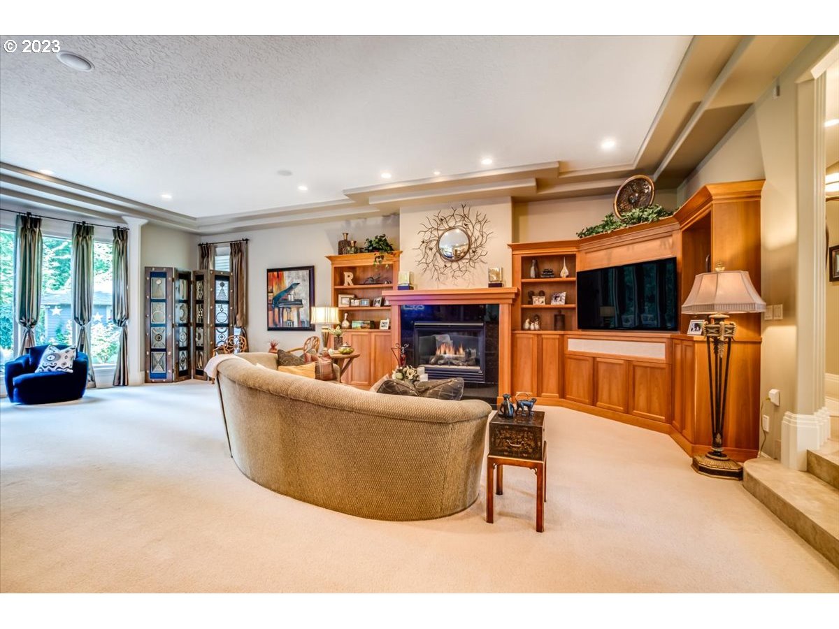 1531 Southeast 26th Drive Gresham, OR 97080 - Photo 14 of 44 a living room with furniture a flat screen tv and a fireplace