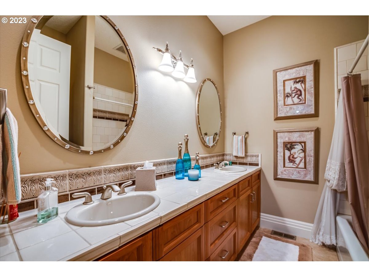 1531 Southeast 26th Drive Gresham, OR 97080 - Photo 25 of 44 a bathroom with a double vanity sink and a mirror