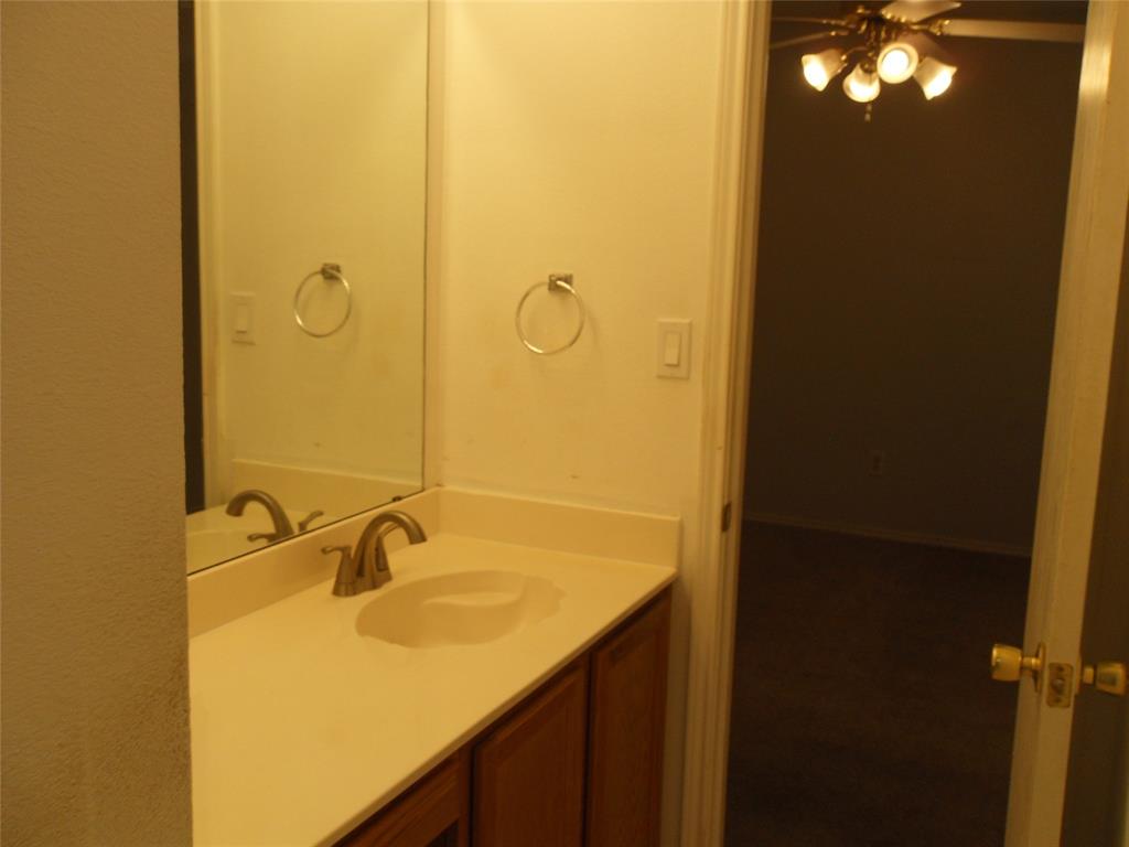 817 Cruise Street Denton, TX 76207 - Photo 13 of 13 a bathroom with a sink and mirror