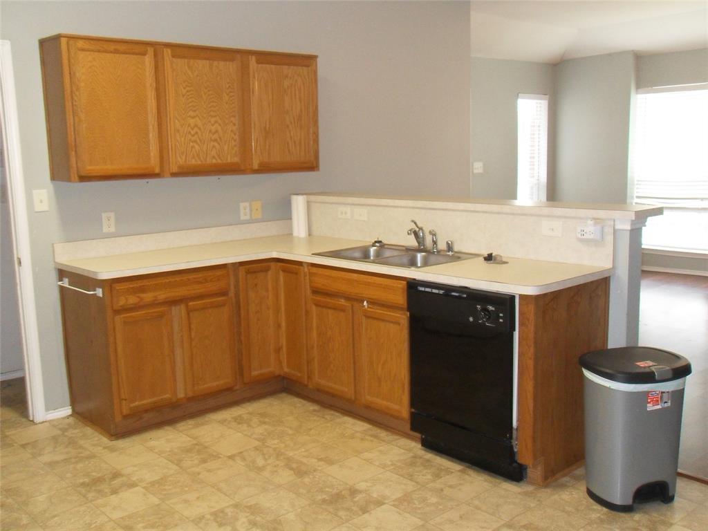 817 Cruise Street Denton, TX 76207 - Photo 4 of 13 a kitchen with a sink and a stove