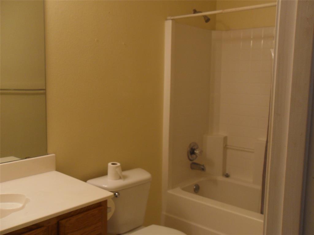 817 Cruise Street Denton, TX 76207 - Photo 7 of 13 a bathroom with a sink and a toilet